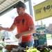 Seeley Farm farm manager Pete Cacciari helps a customer with a radish purchase at the Ann Arbor Farmers Market on the first Wednesday morning market of the season.  Melanie Maxwell I AnnArbor.com